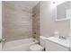 Well-lit bathroom featuring a tub with stylish tiled wall and vanity sink at 1418 Delaware Ave, St Cloud, FL 34769
