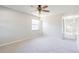Bright bedroom with neutral carpeting, ceiling fan, and ample natural light at 1418 Delaware Ave, St Cloud, FL 34769