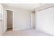 Neutral bedroom showcasing an open door to bathroom and a large closet at 1418 Delaware Ave, St Cloud, FL 34769