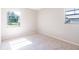 A bright bedroom featuring neutral walls, plush carpeting and natural light at 1418 Delaware Ave, St Cloud, FL 34769
