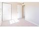 Light-filled bedroom with carpet, closet, and view to hallway at 1418 Delaware Ave, St Cloud, FL 34769