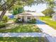 Charming single-story home featuring mature landscaping and a long driveway at 1418 Delaware Ave, St Cloud, FL 34769