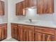 Classic kitchen with wood-grain cabinets, ample countertop space, and a double sink at 1418 Delaware Ave, St Cloud, FL 34769