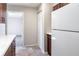 Bright kitchen featuring a white refrigerator, wood-grain cabinets, and durable flooring at 1418 Delaware Ave, St Cloud, FL 34769