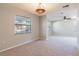 Open living room featuring carpeted floors, neutral walls, and a decorative ceiling light at 1418 Delaware Ave, St Cloud, FL 34769