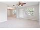 Spacious living room with neutral carpeting, windows, and good natural light at 1418 Delaware Ave, St Cloud, FL 34769