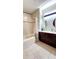 Bright bathroom features a double vanity, tiled floors, and tub with shower at 14620 Golden Rain Tree Blvd, Orlando, FL 32828