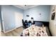 Bedroom with blue walls, ample closet space, and functional furnishings at 14620 Golden Rain Tree Blvd, Orlando, FL 32828