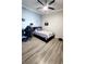 Well-lit bedroom with blue accent wall, ceiling fan, and hard surface floors at 14620 Golden Rain Tree Blvd, Orlando, FL 32828