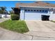 House exterior featuring well-maintained lawn and two-car garage at 14620 Golden Rain Tree Blvd, Orlando, FL 32828