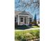 Inviting single-story home with a covered porch, beautiful lawn, and attractive landscaping at 14620 Golden Rain Tree Blvd, Orlando, FL 32828