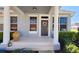 Charming front porch with decorative wreath and manicured landscaping creates an inviting entrance at 14620 Golden Rain Tree Blvd, Orlando, FL 32828