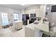 Open kitchen with island, stainless steel appliances, and modern lighting at 14620 Golden Rain Tree Blvd, Orlando, FL 32828