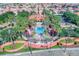 Aerial view of the Solana community pool, surrounded by lush landscaping, homes, and palm trees at 151 Saragossa Ave, Davenport, FL 33897