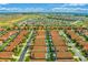 Expansive aerial view showcases a meticulously planned community with orderly streets, uniform homes, and shared green spaces at 151 Saragossa Ave, Davenport, FL 33897