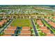 Bird's eye view of a quiet neighborhood, surrounded by an open field and featuring convenient street parking at 151 Saragossa Ave, Davenport, FL 33897