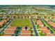 Stunning aerial shot of a quiet neighborhood with well-maintained homes and beautiful green spaces at 151 Saragossa Ave, Davenport, FL 33897