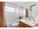 Bathroom featuring a bathtub and shower, toilet, vanity with a sink, and large mirror at 151 Saragossa Ave, Davenport, FL 33897