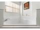 Bright bathroom featuring a soaking tub with tiled surround and a large window for plenty of natural light at 151 Saragossa Ave, Davenport, FL 33897