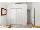 A room showing double doors to a closet, and a doorway to another area at 151 Saragossa Ave, Davenport, FL 33897