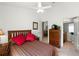 Comfortable bedroom with striped bedding, a ceiling fan, and an en-suite bathroom at 151 Saragossa Ave, Davenport, FL 33897