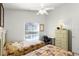 Bedroom featuring twin beds, a ceiling fan, a work desk, and a backyard view at 151 Saragossa Ave, Davenport, FL 33897