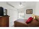 Cozy bedroom with striped bedding, neutral walls, and a ceiling fan for added comfort at 151 Saragossa Ave, Davenport, FL 33897