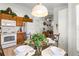 Bright dining area featuring tile flooring, wooden cabinets and white appliances in a cheerful setting at 151 Saragossa Ave, Davenport, FL 33897