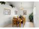 Inviting dining room with a wooden table set for six, complemented by neutral décor and ample lighting at 151 Saragossa Ave, Davenport, FL 33897