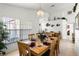Elegant dining room featuring a wooden table set for six, complemented by neutral décor and ample lighting at 151 Saragossa Ave, Davenport, FL 33897
