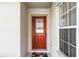 Elegant front door with decorative glass panel and a floral door mat at 151 Saragossa Ave, Davenport, FL 33897
