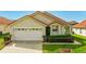 Charming single-Gathering home showcasing a well-manicured front lawn and attached two-car garage at 151 Saragossa Ave, Davenport, FL 33897