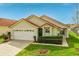 Charming single-Gathering home showcasing a well-manicured front lawn and attached two-car garage at 151 Saragossa Ave, Davenport, FL 33897