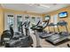 Well-equipped gym with treadmills, elliptical machines, and large windows for natural light and views at 151 Saragossa Ave, Davenport, FL 33897