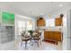 Bright kitchen with tile floors, wood cabinets, and a glass-top dining table with seating for four at 151 Saragossa Ave, Davenport, FL 33897