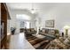Open concept living room with views of screened patio, tile flooring, and lots of natural light at 151 Saragossa Ave, Davenport, FL 33897