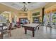 Spacious lobby with a chandelier, pool table, and comfortable seating areas, creating a welcoming atmosphere at 151 Saragossa Ave, Davenport, FL 33897