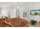 Bright main bedroom featuring a fan, access to a patio, and a mounted television at 151 Saragossa Ave, Davenport, FL 33897