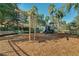 Community playground with swings, slides, and play structure surrounded by a secure black fence at 151 Saragossa Ave, Davenport, FL 33897