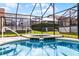 Relaxing spa and refreshing screened-in pool offer a perfect outdoor oasis with privacy at 151 Saragossa Ave, Davenport, FL 33897