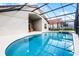 Inviting screened-in pool and spa offer a refreshing escape in a private backyard setting at 151 Saragossa Ave, Davenport, FL 33897