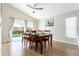 Well-lit dining room with a wood table, sliding glass doors to the pool, and wood-look tile flooring at 153 Laurel Ridge Pass, Davenport, FL 33897