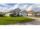 Well-maintained home featuring a spacious, green front yard, a two car garage, and an inviting facade at 153 Laurel Ridge Pass, Davenport, FL 33897