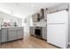 Bright kitchen featuring stainless steel appliances, gray cabinets, and wood-look tile floors at 153 Laurel Ridge Pass, Davenport, FL 33897