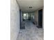 Well-lit hallway with stone flooring, ornate benches, and unit doors at 175N Pearl Lake Cswy # 114, Altamonte Springs, FL 32714