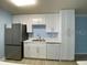 Modern kitchen featuring white cabinets, stainless steel appliances, and light countertops at 175N Pearl Lake Cswy # 114, Altamonte Springs, FL 32714