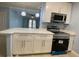 Bright kitchen features stainless appliances, quartz countertops, and ample cabinet space at 175N Pearl Lake Cswy # 114, Altamonte Springs, FL 32714