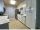 Bright kitchen featuring white cabinets, stainless steel appliances, and wood-look flooring at 175N Pearl Lake Cswy # 114, Altamonte Springs, FL 32714