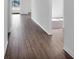 Long hallway featuring wood grain floors leads to an open space at the end at 1919 Escambia Ln, Kissimmee, FL 34759