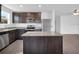Modern kitchen features stainless steel appliances, granite countertops, and dark cabinets at 1919 Escambia Ln, Kissimmee, FL 34759